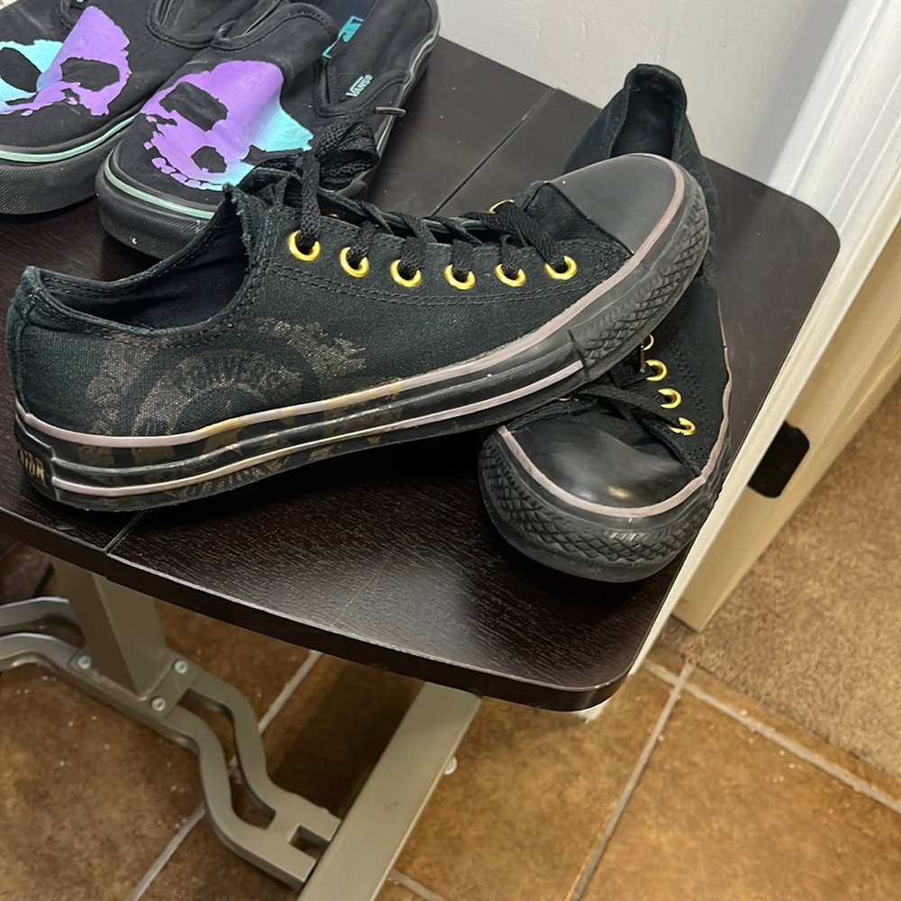 a all black low top converse with gold embellishments Women Size 9